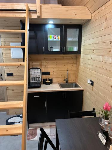 a small kitchen with a sink and a table at La - Mai Glamping in Žetale