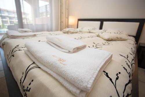 two beds with white towels on top of them at Kaliakria Resort in Topola
