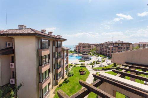 an apartment with a view of a courtyard with a pool at Kaliakria Resort in Topola