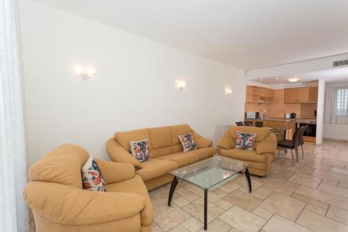 a living room with two couches and a table at Kaliakria Resort in Topola