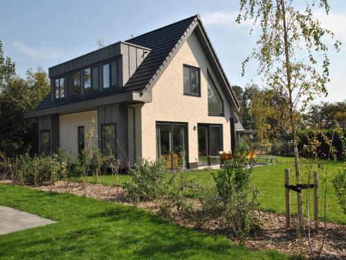 a house with a black roof at Villa in Texel near Beach and Nature Reserve in Westermient