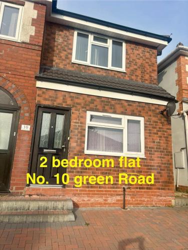 a sign on the side of a brick house at 2 bed flat in Dudley