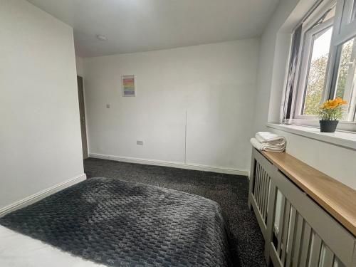 an empty room with a bench and a window at 2 bed flat in Dudley