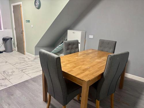 a wooden table and chairs in a room at 2 bed flat in Dudley