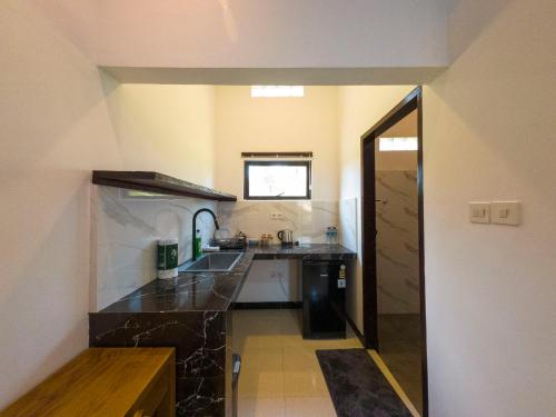 a large kitchen with a sink and a counter at Mar Bella Beachfront in Kuta Lombok