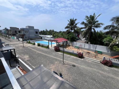 an overhead view of a swimming pool and a house at Brownie beach house in Covelong