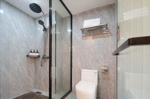 a bathroom with a shower and a toilet in it at Dori1993 Hotel in Changsha
