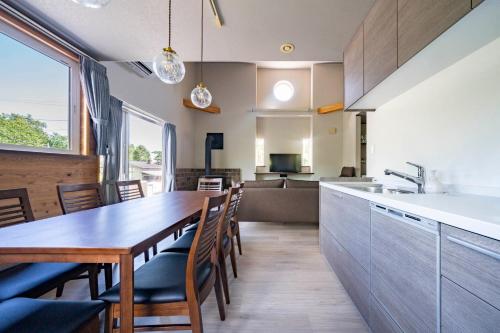 a kitchen and dining room with a wooden table and chairs at Niseko Mt Village in Niseko
