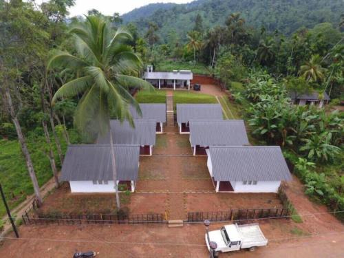 an aerial view of a group of benches in a field at Sinharaja Forest Sanctuary in Deniyaya