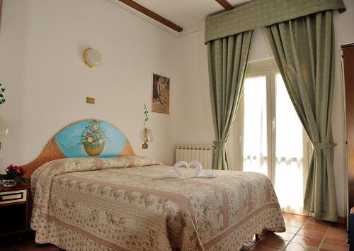 Postel nebo postele na pokoji v ubytování Albergo Ristorante Ferretti