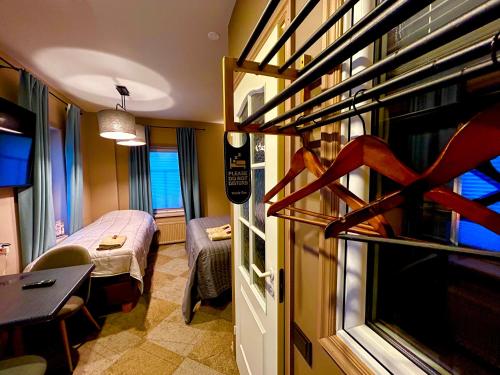 a small room with a room with a bed and a room with a room at Traditional Narva House in Narva