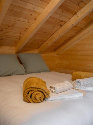a brown towel on a bed in a attic at Les 3 Chalets de Cilaos in Cilaos