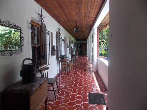 a hallway of a house with a red tile floor at Hotel Casa Duranta in Cobán