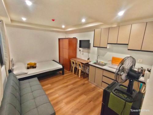a kitchen with a couch and a table in a room at 2F-14 City Center Cozy Condo at Megatower 4 in Baguio