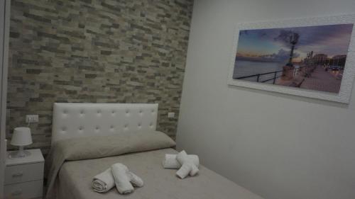 a bedroom with a bed with two towels on it at Marselo B&B in Bari