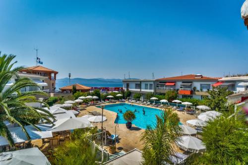 a view of the pool at a resort with umbrellas at Best Western Plus La Marina in Saint-Raphaël