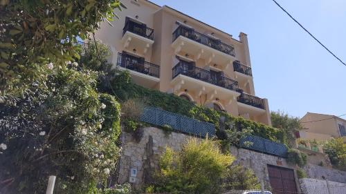 a building on the side of a hill at Linardos Apartments in Asos
