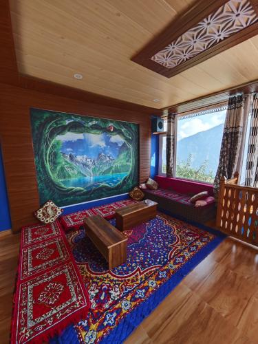 a living room with a large painting on the wall at The District Green in Kalpa