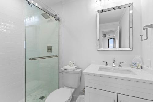 a bathroom with a toilet and a sink and a shower at Summer House 202 - 3BR Oceanfront Condo! View! in Isle of Palms