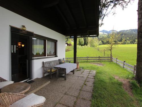 a patio with a table and benches and a field at Chalet in St Johann near Ski Slopes in Alpendorf
