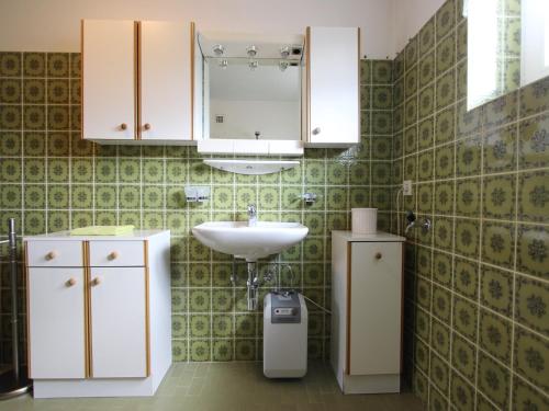 a bathroom with a sink and a mirror at Chalet in St Johann near Ski Slopes in Alpendorf