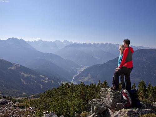 a man and a woman sitting on top of a mountain at Chalet in St Johann near Ski Slopes in Alpendorf