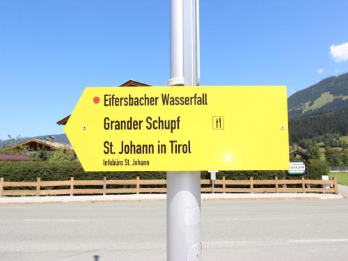 a yellow street sign on the side of a road at Chalet in St Johann near Ski Slopes in Alpendorf