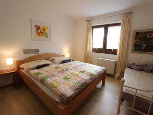 a bedroom with a bed with a quilt on it at Chalet in St Johann near Ski Slopes in Alpendorf