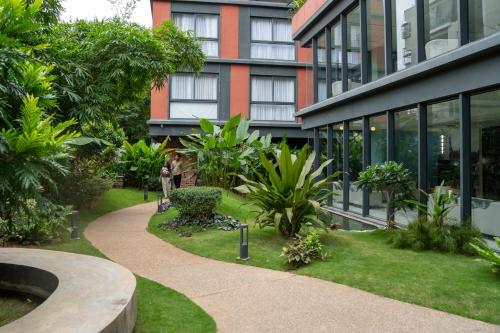 a building with a garden in front of a building at Priya Hyderabad in Hyderabad