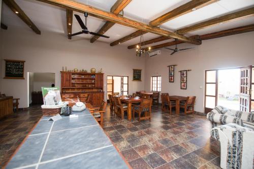 a large living room with a table and chairs at Foreva Wild in Klipdrift