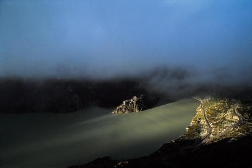an aerial view of a mountain with a body of water at Historisches Alpinhotel Grimsel Hospiz in Grimsel Hospiz