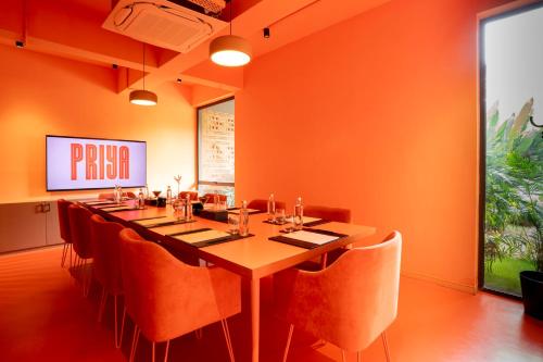 a dining room with a long table and chairs at Priya Hyderabad in Hyderabad