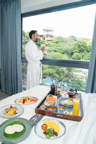 a man standing in front of a table of food at Priya Hyderabad in Hyderabad