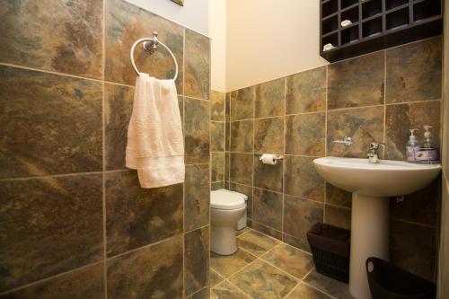 a bathroom with a sink and a toilet at Foreva Wild in Klipdrift