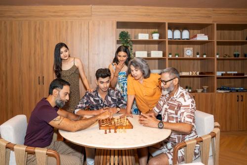 a group of people sitting around a table playing chess at Priya Hyderabad in Hyderabad