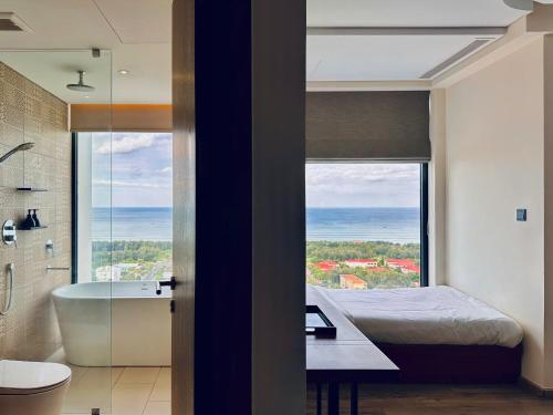 a bathroom with a bed and a bath tub and a window at Kira Kira 's Apartment, Apec Mandala Phu Yen Condotel in Tuy Hoa