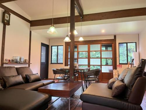 a living room with a couch and a table at ホシヤドリ hoshiyadori in Setouchi