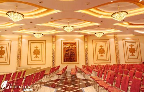 a conference room with a glass table and red chairs at The Golden leaf hotel in Gaya
