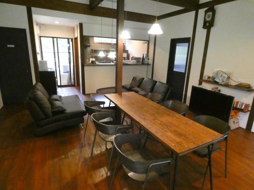 a living room with a wooden table and chairs at ホシヤドリ hoshiyadori in Setouchi
