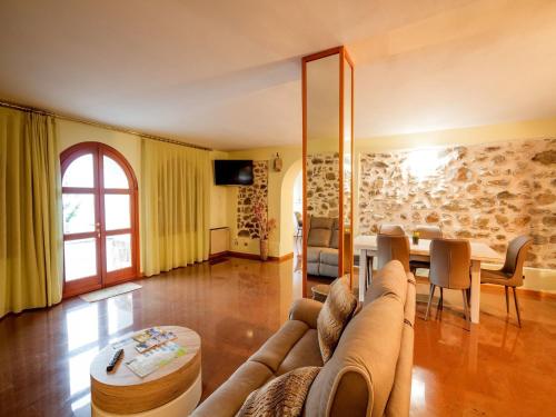 a living room with a couch and a table at Lakeside Mansion with Pool in Artogne
