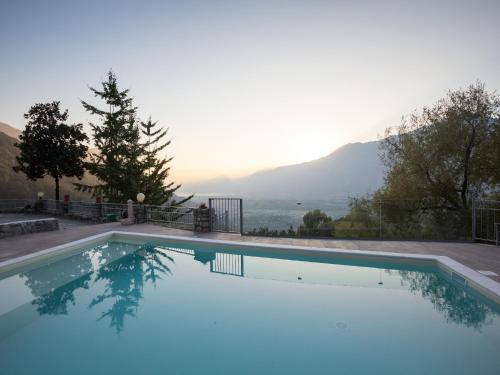 a swimming pool with a view of the mountains at Lakeside Mansion with Pool in Artogne
