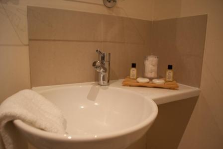 a bathroom with a sink with a towel on it at The Hare and Hounds in Fulbeck