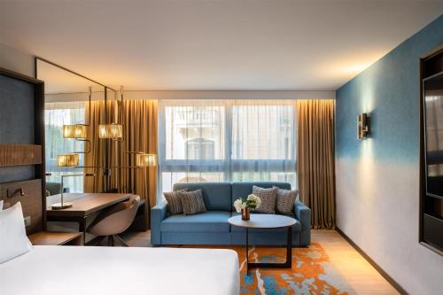 a living room with a blue couch and a table at Hyatt Regency Malta in St Julian's