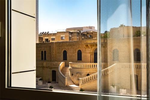 a view of a building from a window at Hyatt Regency Malta in St Julian's