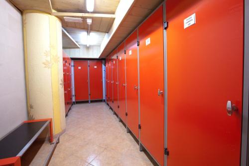 a row of orange lockers in a locker room at Hotel Angelica in Livigno