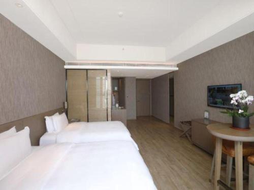 Postel nebo postele na pokoji v ubytování Mangrove Tree Resort World Qingdao