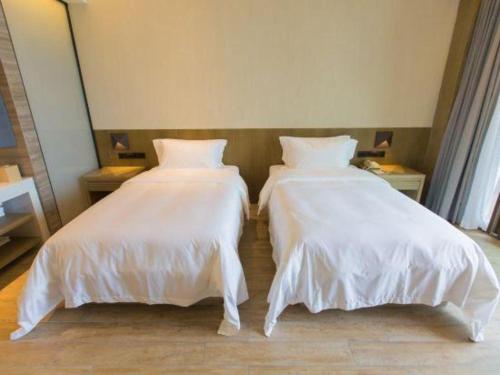 Postel nebo postele na pokoji v ubytování Mangrove Tree Resort World Qingdao