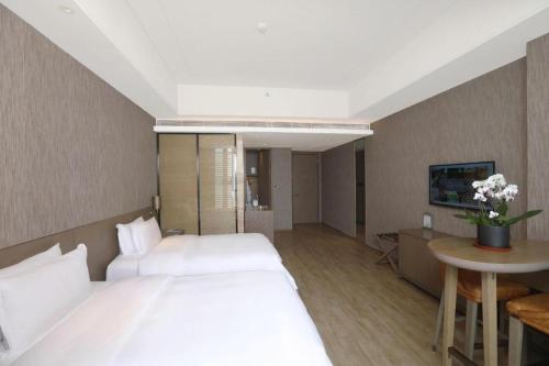 Postel nebo postele na pokoji v ubytování Mangrove Tree Resort World Qingdao