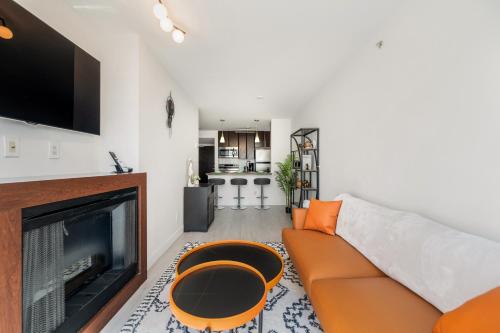 a living room with a couch and a fireplace at Modern Condo in Downtown Vancouver in Vancouver