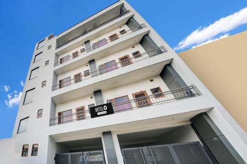 a white apartment building with a sign on it at Collection O Kalpana Chawla Hospital Karnal in Karnal